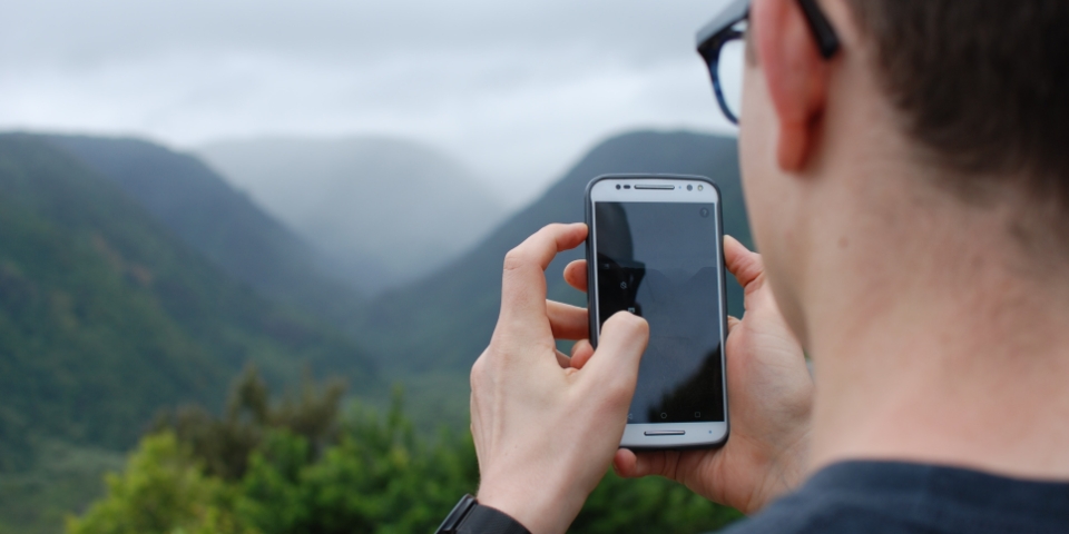 man with cellphone in mountains