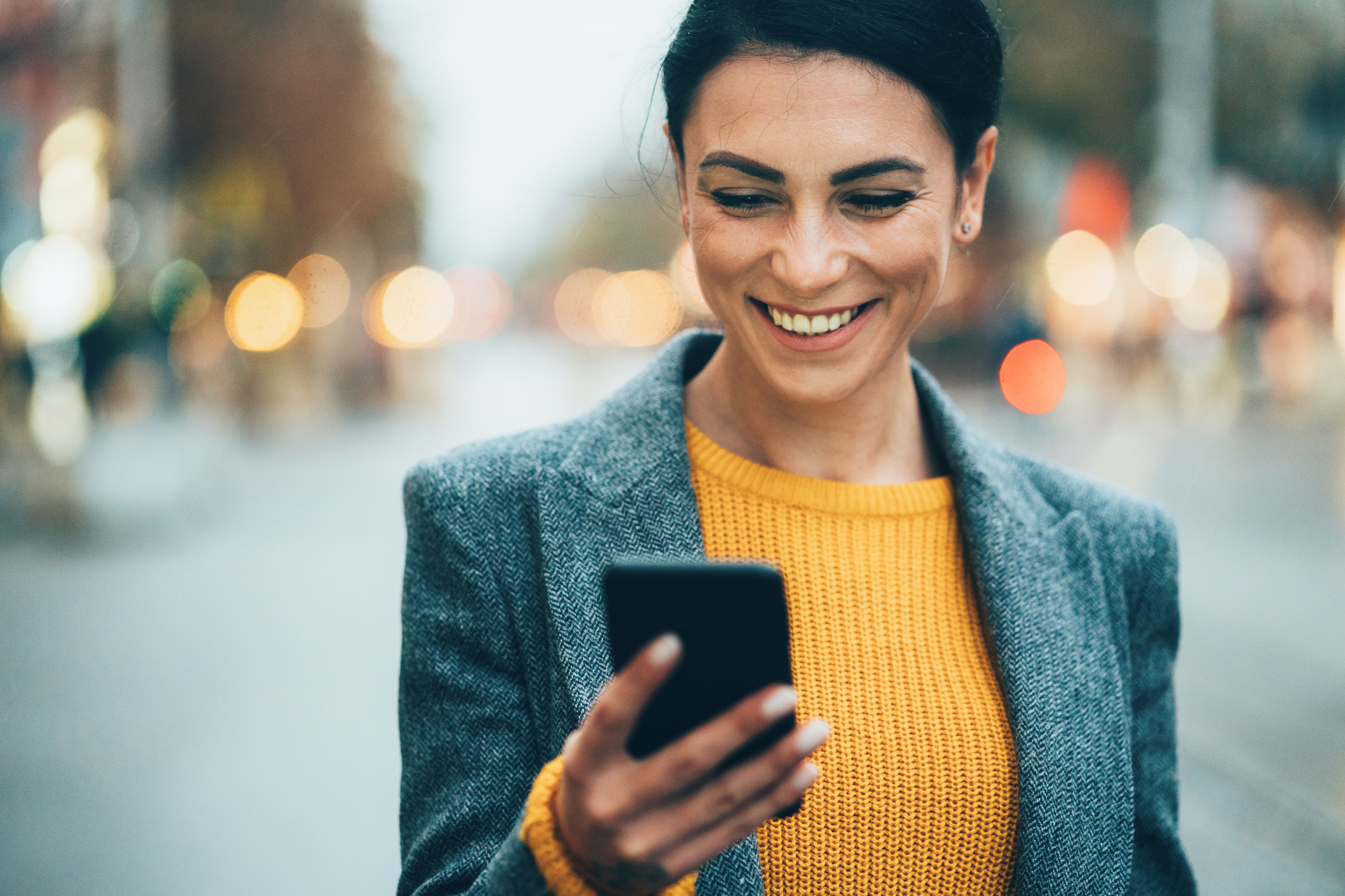 woman smiling at cellphone