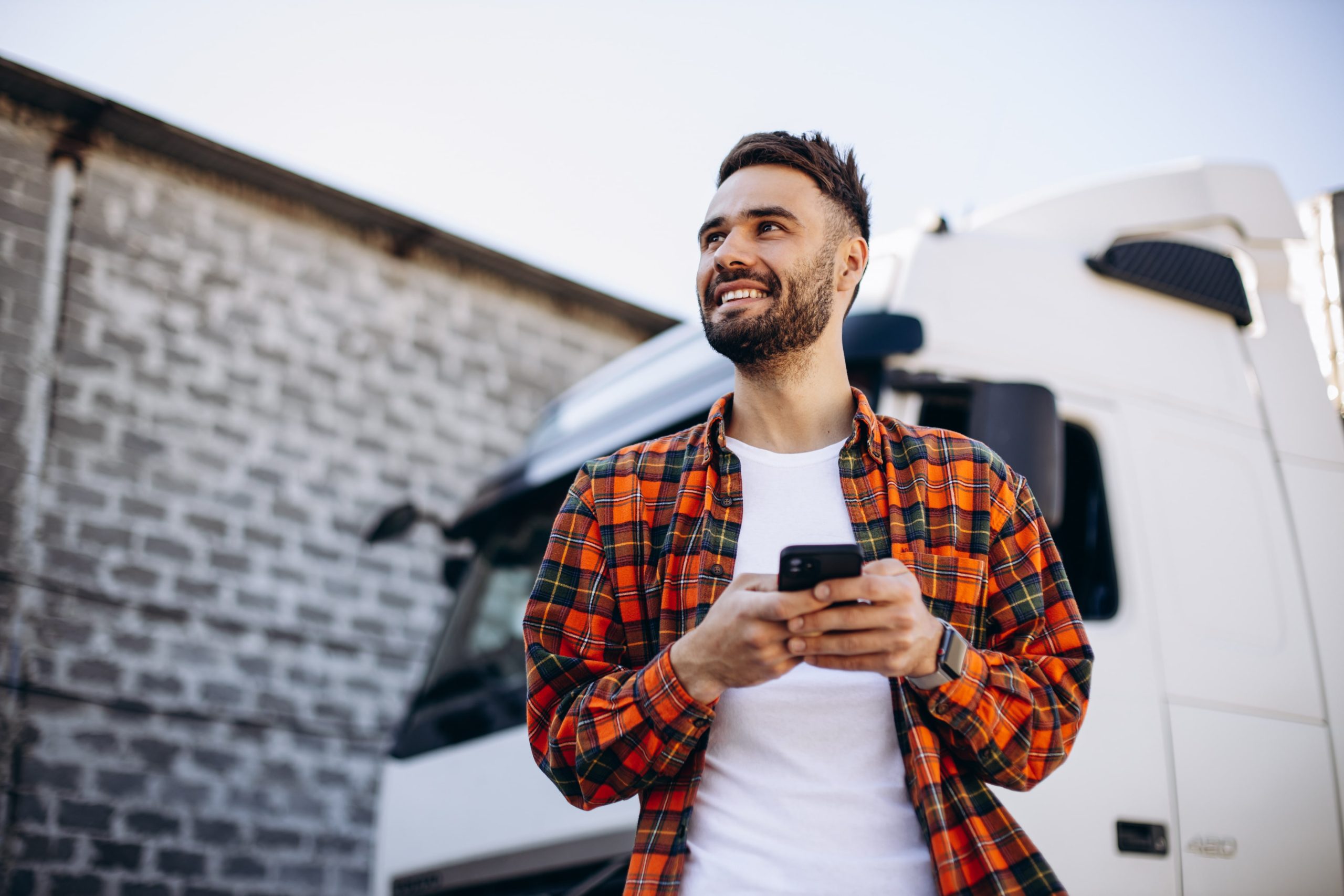 man in flannel with cellphone
