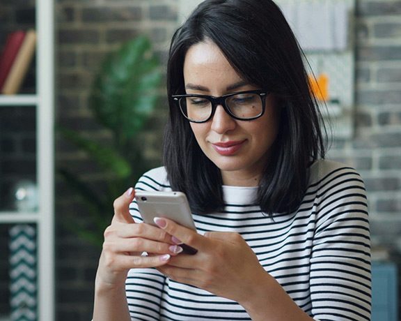 bulk_recipient woman looking at her phone and smirking