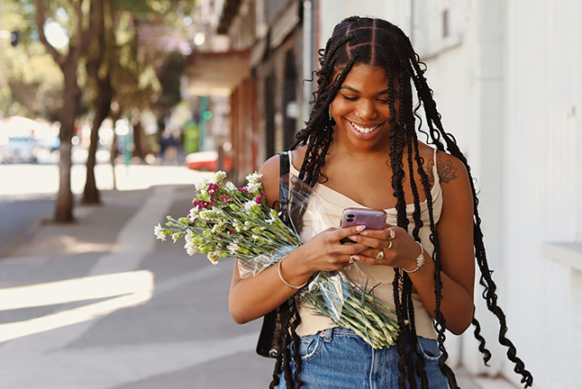 a woman holding flowers and smiling
