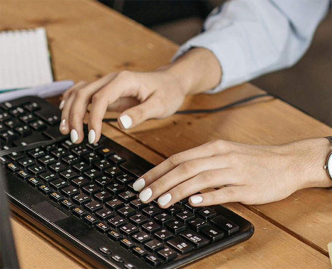two hands typing on a mechanical keyboard