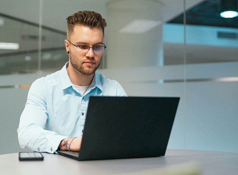business man in button shirt typing on black laptop