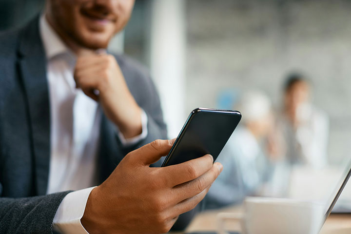 MSP-man-in-suit man in suit looking at a black phone