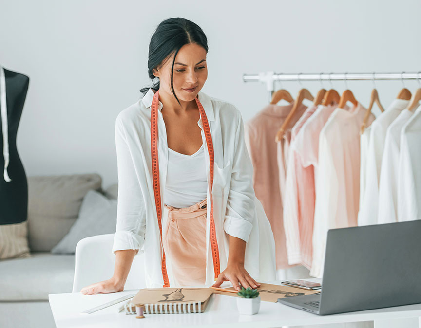 clothes designer looking at laptop