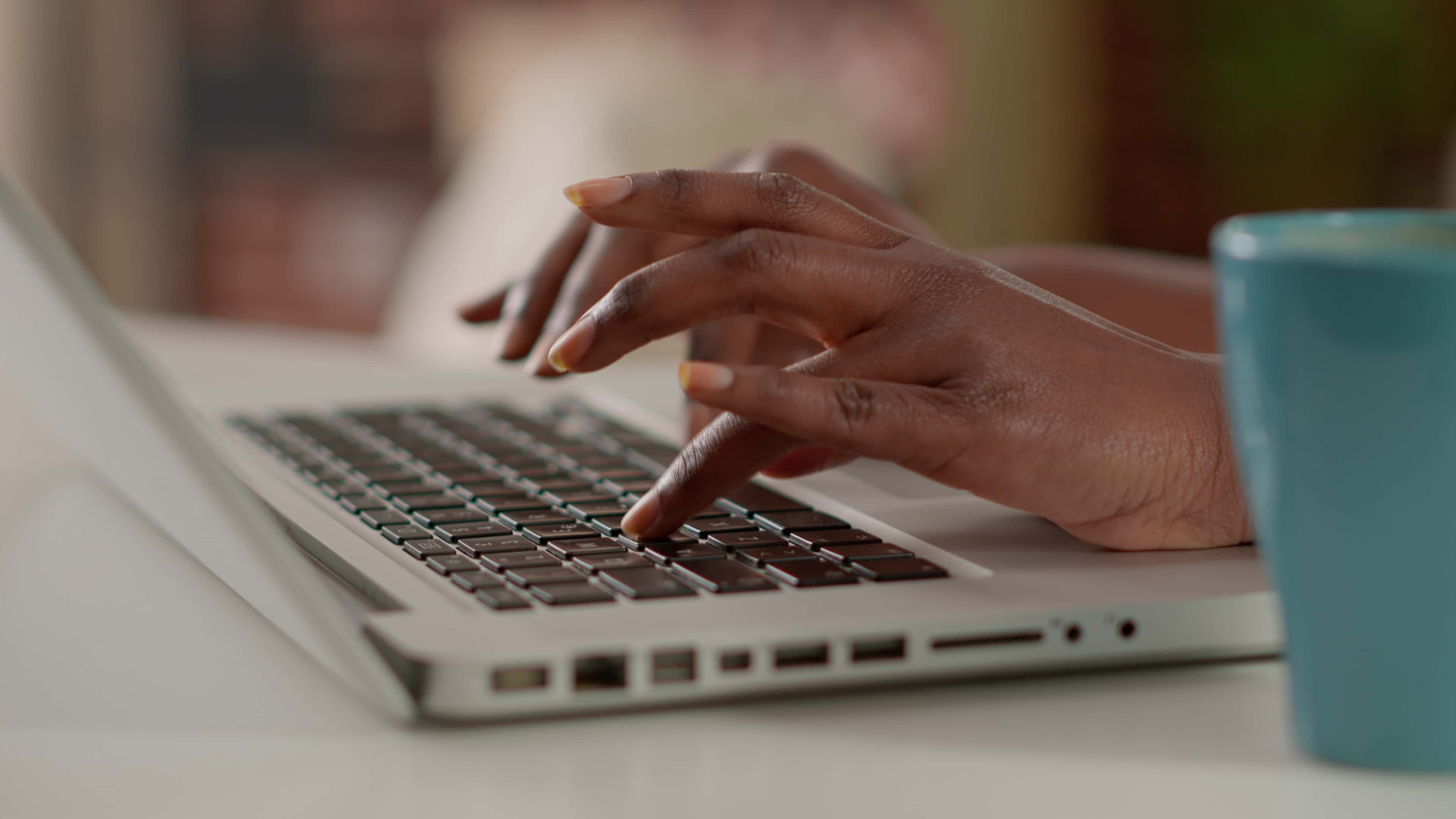 A person typing on their laptop