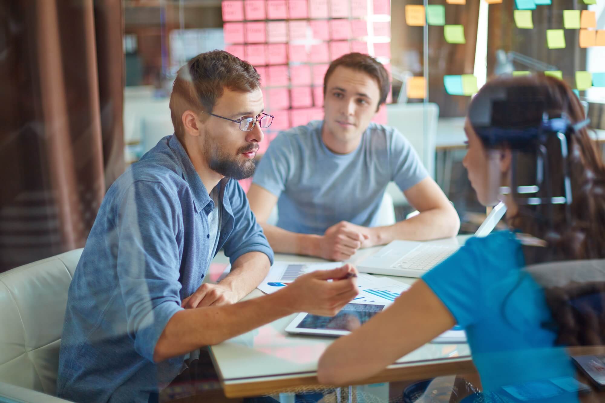 young people talking at a conference room table